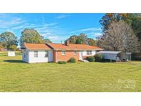 Ranch-style brick home with carport and spacious yard at 1995 Gastonia Hwy, Lincolnton, NC 28092