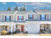 Tan and red three-story townhome with attached garage and landscaping at 206 River Clay Rd, Fort Mill, SC 29708