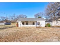 White house with gray roof, front porch, and a yard at 304 Edel St, Kings Mountain, NC 28086