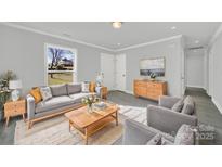 Bright living room with gray sofa and wood coffee table at 624 Gaywood Dr, Charlotte, NC 28273