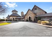 Beautiful exterior facade of clubhouse with stone and painted brick and well maintained grounds at 9307 Dufaux Dr, Charlotte, NC 28278