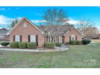 Brick house with landscaping, driveway, and a two-car garage at 1011 Emerson Dr, Mooresville, NC 28115