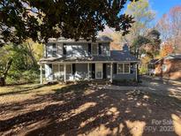 Charming two-story house with a gray exterior and well-maintained lawn at 1024 Eaglewood Ave, Charlotte, NC 28212