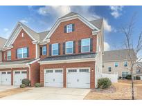 Brick front exterior of townhome with two-car garage and landscaping at 105 Clarendon St # E, Mooresville, NC 28117