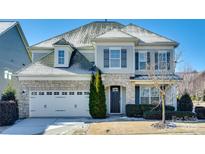 Two-story house with stone accents and a three-car garage at 1056 Emory Ln, Fort Mill, SC 29708