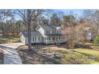 Two-story house with gray siding, porch, and a landscaped yard at 13010 Marlstone Ln, Charlotte, NC 28215