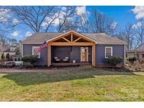 Charming renovated home with a welcoming front porch and landscaped lawn at 1334 Woodland Dr, Charlotte, NC 28205