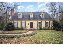 Charming yellow house with a brick pathway, and well-manicured lawn at 1346 5Th Street Nw Cir, Hickory, NC 28601