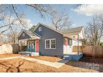 Gray house with pink door, fenced yard, and walkway at 2514 Ringwood St, Charlotte, NC 28208