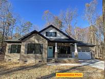 Brick house with white accents, two-car garage, and a nice front yard at 305 General As Johnston St, Stanley, NC 28164