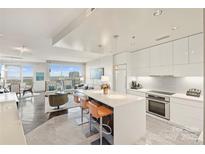 Modern white kitchen with island and stainless steel appliances at 333 W Trade St # 1204, Charlotte, NC 28202