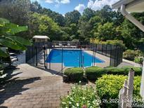 Inviting in-ground pool with safety fence, perfect for summer fun at 44101 Millingport Rd, Richfield, NC 28137