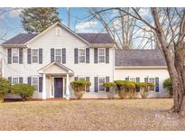 Two-story house with gray siding, dark shutters, and landscaping at 9005 Jaldena Dr, Charlotte, NC 28227