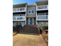 Brick building exterior with stairs leading to condo entrance at 9401 Old Concord Rd # A, Charlotte, NC 28213