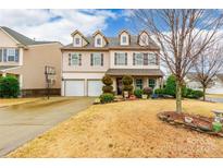 Two-story house with beige siding, two-car garage, and landscaped yard at 1147 Wagner Ave, Fort Mill, SC 29715
