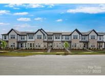 Beautiful new townhome community with manicured landscaping and inviting facade at 3107 Beacon Heights Rd, Indian Land, SC 29707