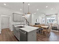 Open concept kitchen with island, stainless steel appliances and gray cabinets at 3107 Beacon Heights Rd, Indian Land, SC 29707