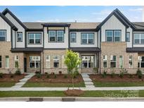 Charming townhome exterior featuring a combination of brick and siding, complemented by well-maintained landscaping at 3109 Beacon Heights Rd, Indian Land, SC 29707