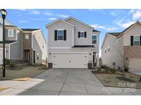 Two-story house with gray siding, black shutters, and a two-car garage at 337 Hyssop Ct, Fort Mill, SC 29715