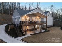 Stunning exterior showcasing a two-story deck and outdoor living spaces, perfect for enjoying nature at 42610 Moonshine Dr, New London, NC 28127