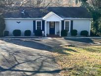 Ranch style home with blue shutters and a neatly landscaped yard at 7381 Norman Dr, Sherrills Ford, NC 28673