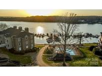 Beautiful aerial view of condo community with pool, lake access, and boat docks at sunset at 9801 Emerald Point Dr # 2, Charlotte, NC 28278