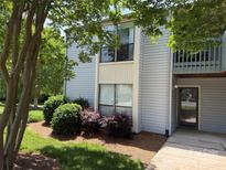 Charming two-story condo with neutral siding, mature trees, and manicured landscaping at 11121 S Harrowfield Rd, Charlotte, NC 28226