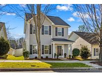 Two-story house with gray siding, black shutters, and a front porch at 19510 Deer Valley Dr, Cornelius, NC 28031