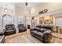 Spacious living room featuring hardwood floors, a high ceiling, and leather furniture at 311 Kaitlyn Ln, Kings Mountain, NC 28086