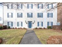 Two-story building exterior with blue shutters and a walkway at 3809 Carl Parmer Dr, Harrisburg, NC 28075