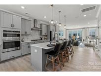 Modern kitchen with island, stainless steel appliances, and ample counter space at 5029 Westmead Ln, Charlotte, NC 28262