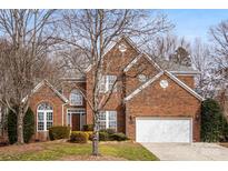 Brick house with two-car garage and mature trees at 2330 Oberwood Dr, Charlotte, NC 28270
