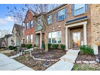 Brick townhouse with landscaped front yard and walkway at 3033 Honeylocust Ln, Fort Mill, SC 29707