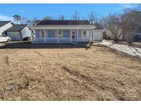 Charming light blue house with a front porch and well-maintained lawn at 4210 Manchester Ln, Monroe, NC 28110