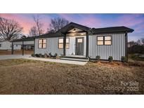 Stunning modern farmhouse exterior with carport at 516 Spring Garden Ave, Kannapolis, NC 28081