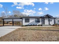 Modern farmhouse exterior with carport and landscaping at 516 Spring Garden Ave, Kannapolis, NC 28081