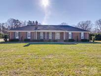 Attractive brick home with blue shutters, manicured lawn, and a welcoming entrance at 7169 Pleasant Grove Rd, Charlotte, NC 28216