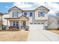 Charming two-story home featuring a two-car garage and beautifully landscaped front yard at 17311 Carolina Hickory Dr, Huntersville, NC 28078