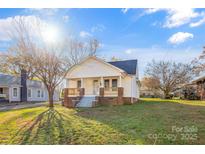 Charming one-story house with brick accents and a spacious front yard at 1102 Venus St, Kannapolis, NC 28083