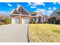 Beautiful brick home with attached garage, well-maintained lawn and manicured landscaping at 144 Spring Forest Dr, Shelby, NC 28152