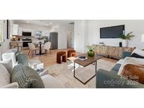 Open concept living area with kitchen views and hardwood floors at 2212 Jackson St, Belmont, NC 28012