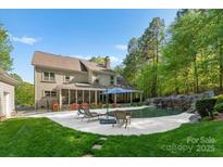 Luxury home with a private pool, waterfall, and spacious patio at 227 Wildwood Cove Dr, Mooresville, NC 28117