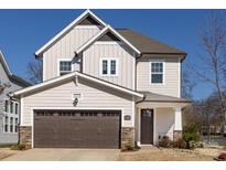 Charming two-story home with neutral siding, stone accents, and a two-car garage on a sunny day at 433 Belton St, Charlotte, NC 28209