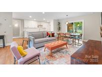 Open concept living and dining area with hardwood floors and access to the backyard at 4715 Northaven Dr, Charlotte, NC 28206