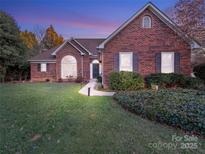 Brick ranch home with landscaped lawn at 758 Emerson Dr, Mooresville, NC 28115