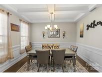 Formal dining room with a chandelier, hardwood floors, and wainscoting at 136 Margo Ln, Statesville, NC 28677
