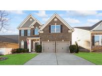 Beautiful two-story brick home featuring a two-car garage and manicured front lawn at 136 Margo Ln, Statesville, NC 28677