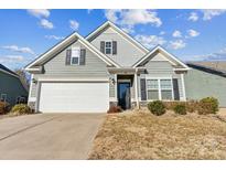 Gray two-story house with white garage door and landscaping at 1415 Troon Dr, Salisbury, NC 28144