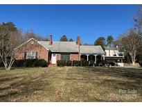 Brick ranch house with a covered porch and large yard at 916 Maple Ave, Salisbury, NC 28144