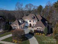 Brick house with a three-car garage, and circular driveway at 2002 Streamview Ct, Waxhaw, NC 28173